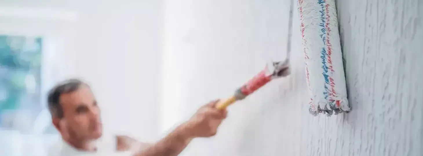 Man painting walls in home